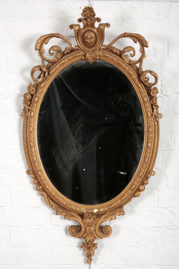 A LATE VICTORIAN GILT GESSO OVAL WALL MIRROR