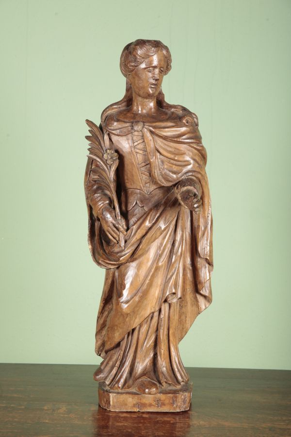 A CARVED LIMEWOOD FIGURE OF ST CATHERINE OF ALEXANDRIA