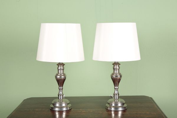 A PAIR OF SILVERED TABLE LAMPS