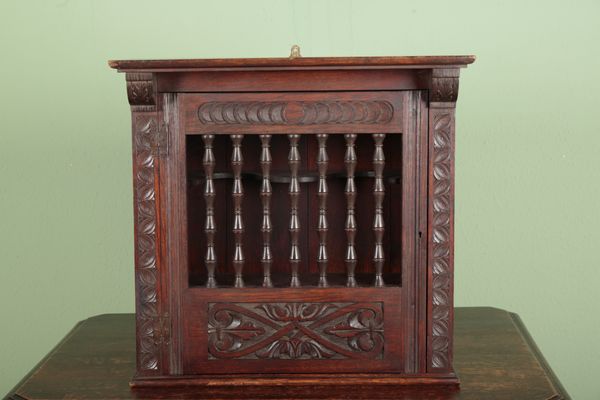 AN OAK CUPBOARD