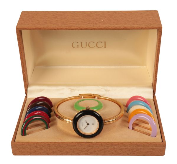 GUCCI "CHANGE": A LADY'S GOLD-PLATED BRACELET WATCH