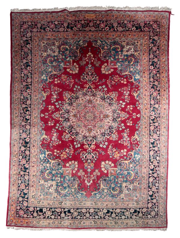 A LARGE SIGNED PERSIAN CARPET