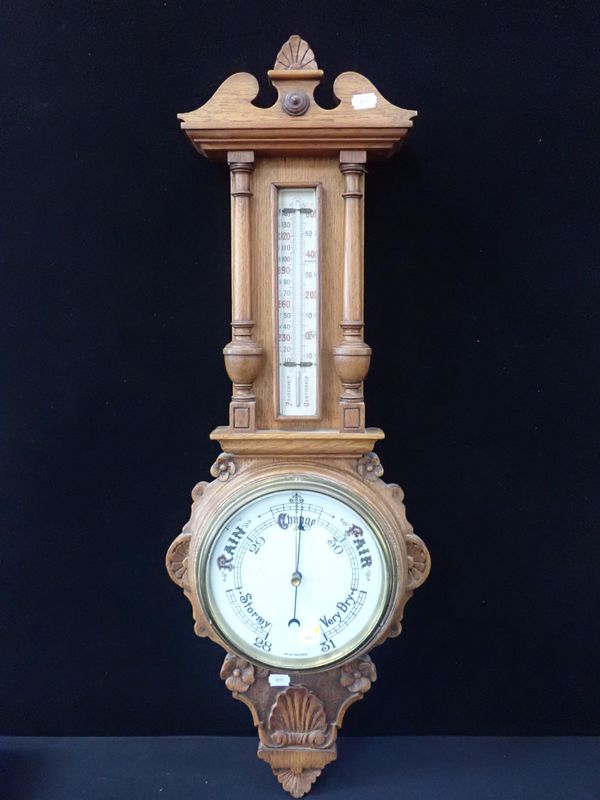 A VICTORIAN OAK-CASED ANEROID BAROMETER