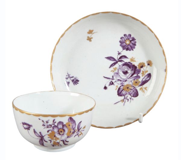 A NOVE PORCELAIN TEA BOWL AND SAUCER
