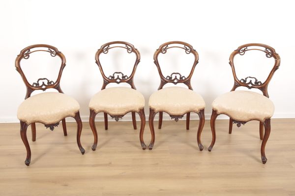 FOUR VICTORIAN CARVED WALNUT BALLOON BACK CHAIRS IN ROCOCO STYLE