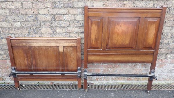 A 1930s OAK SINGLE BED WITH PANELLED ENDS