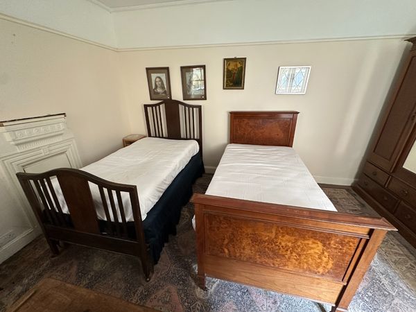A STAINED OAK SINGLE BED