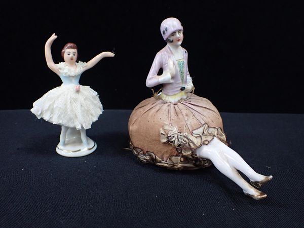 A 1920s PORCELAIN PIN CUSHION DOLL