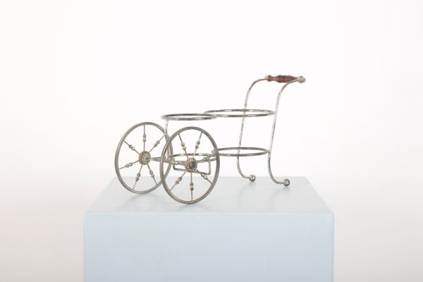 A SILVER PLATED BOTTLE TROLLEY
