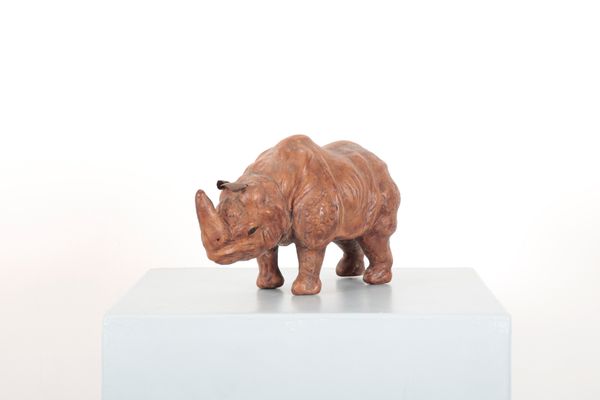 A SMALL LEATHER BROWN RHINOCEROS IN THE STYLE OF LIBERTY'S, LONDON