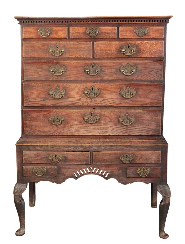 A GEORGE II OAK CHEST ON STAND