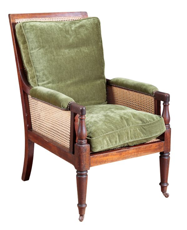 A REGENCY MAHOGANY BERGÈRE LIBRARY CHAIR