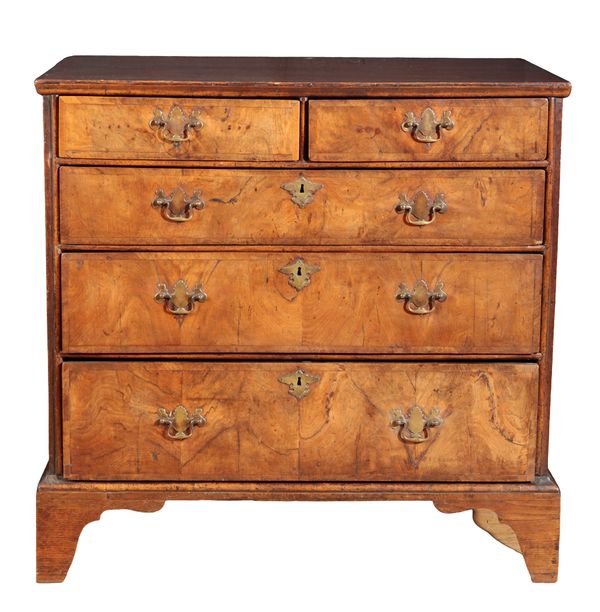 A GEORGE I WALNUT AND OAK CHEST OF DRAWERS