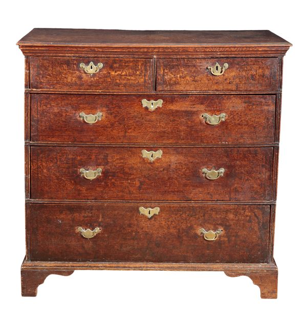 AN OAK CHEST OF DRAWERS