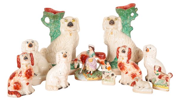 A PAIR OF 19TH CENTURY STAFFORDSHIRE POTTERY SPANIEL SPILL VASES