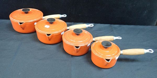 A SET OF CAST IRON GRADUATED COUSANCES SAUCEPANS