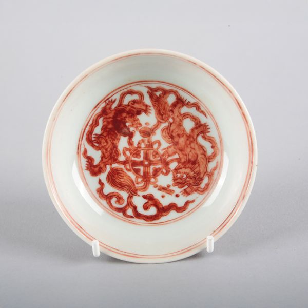 A CHINESE PORCELAIN IRON RED 'LION' SAUCER