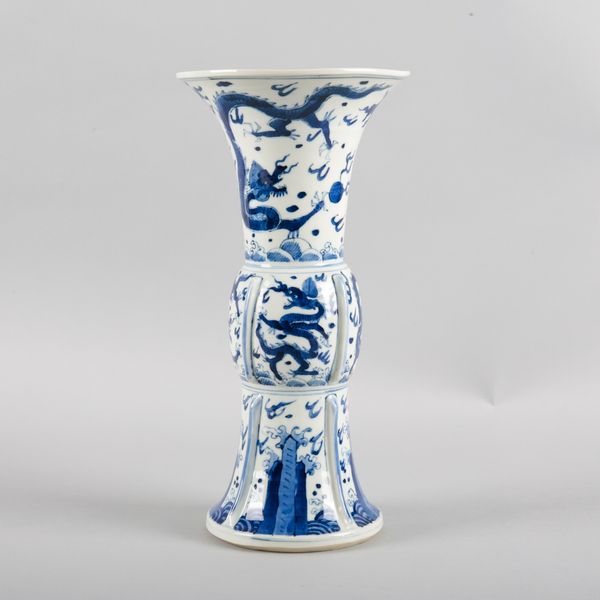 A CHINESE PORCELAIN BLUE AND WHITE 'DRAGON' GU VASE