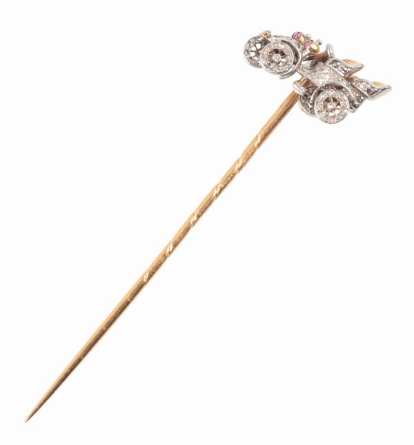 A CAR STICK PIN SET WITH RUBIES AND DIAMONDS