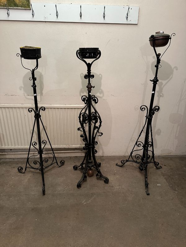 A GROUP OF THREE VICTORIAN COPPER AND WROUGHT IRON STANDING LAMP BASES