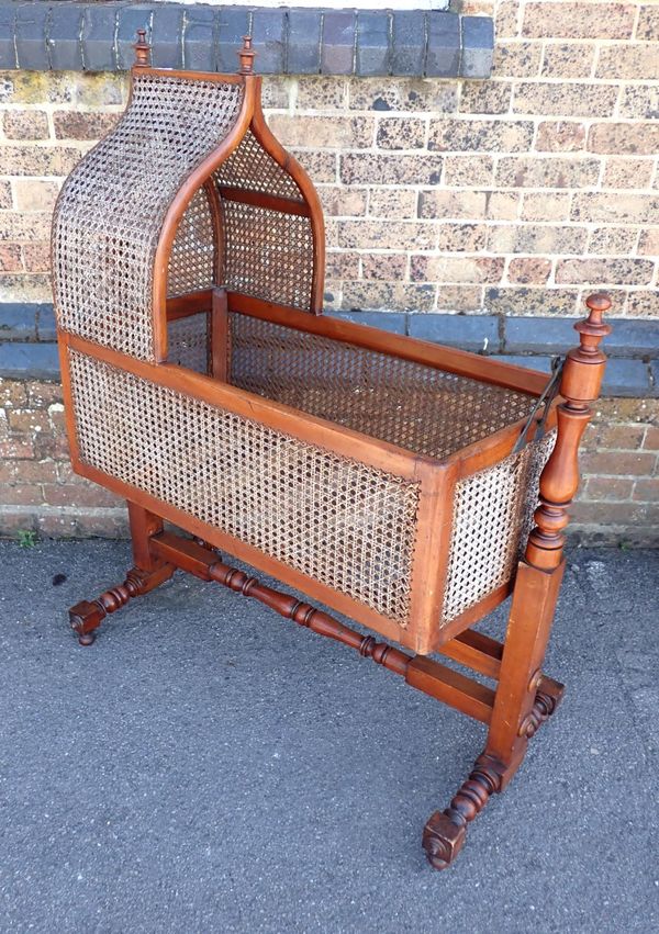 A 19th CENTURY MAHOGANY AND CANEWORK CRIB