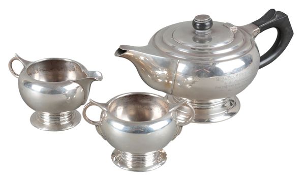 A GEORGE VI SILVER THREE PIECE TEA SERVICE OF ART DECO STYLE