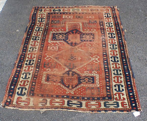 AN ANTIQUE KAZAK RUG