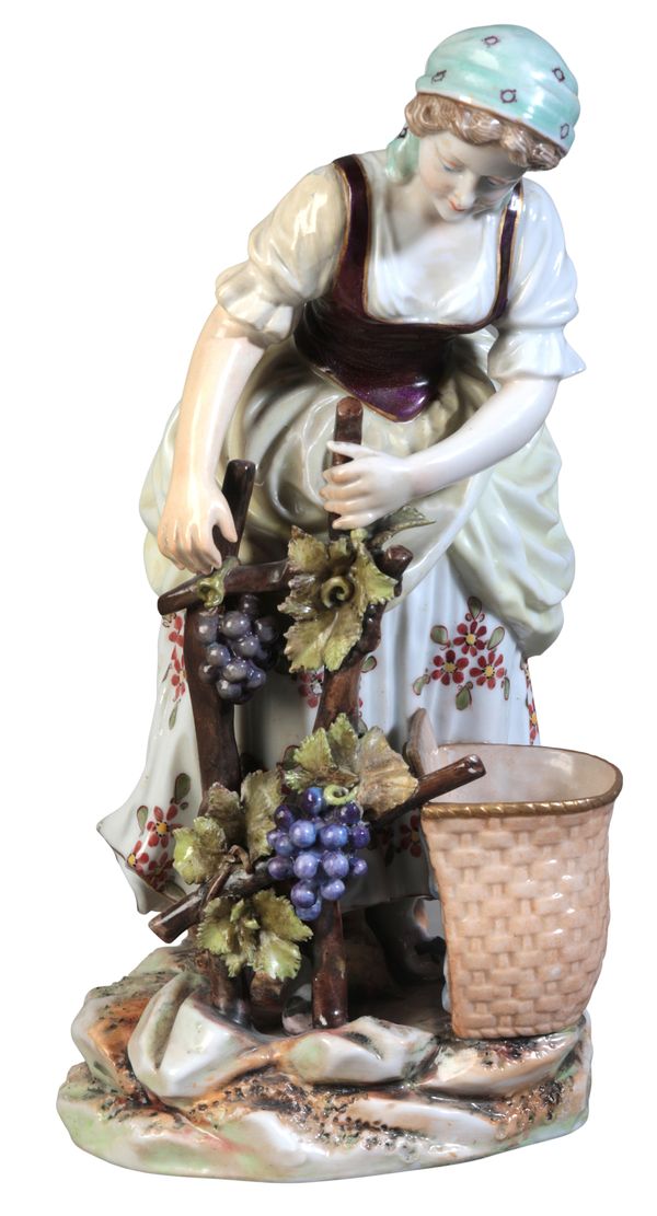 A CONTINENTAL PORCELAIN FIGURE OF A GRAPE HARVESTER