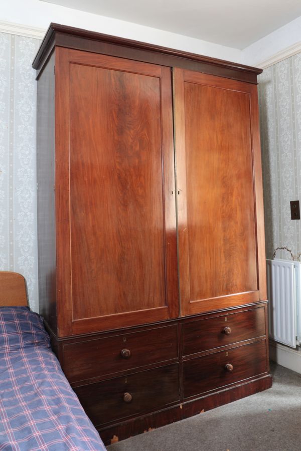 AN EDWARDIAN MAHOGANY PRESS CUPBOARD