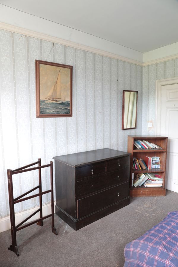 A STAINED OAK CHEST OF DRAWERS