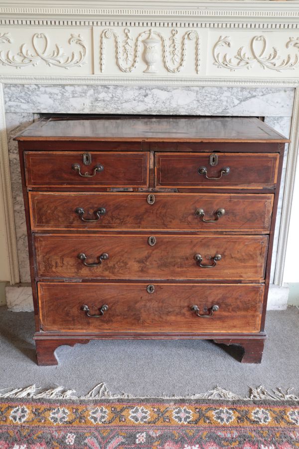 A WALNUT CHEST OF DRAWERS