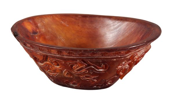 A CHINESE CARVED BUFFALO HORN LIBATION CUP