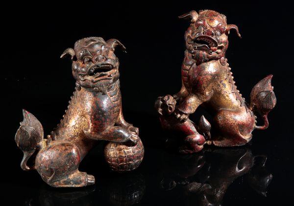 AN OPPOSING PAIR OF GILT METAL LION DOG CENSERS