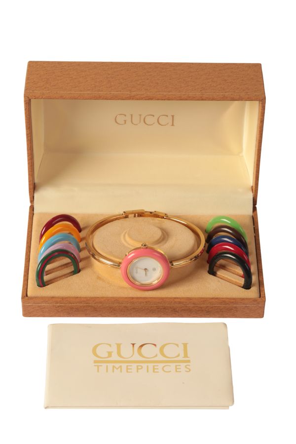 GUCCI: A LADY'S GOLD-PLATED BANGLE WATCH