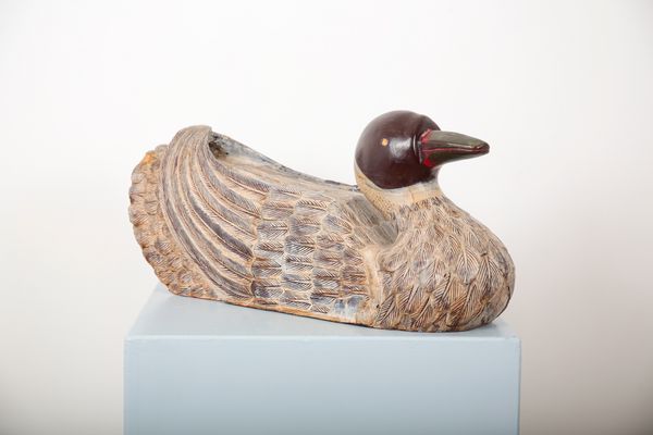 A CARVED AND PAINTED LARGE FOLK ART DUCK