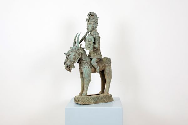 A VERDIGRIS PATINATED BENIN WARRIOR ON HORSEBACK