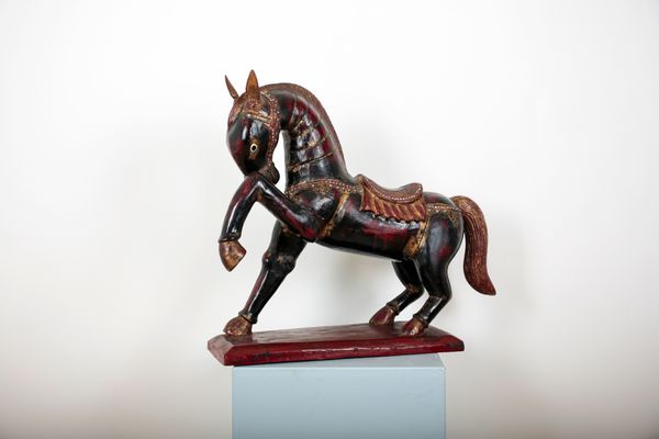 AN ASIAN POLYCHROME CARVED WOODEN HORSE