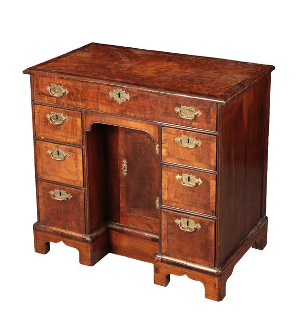 A GEORGE II BURR WALNUT AND MAHOGANY KNEEHOLE DESK