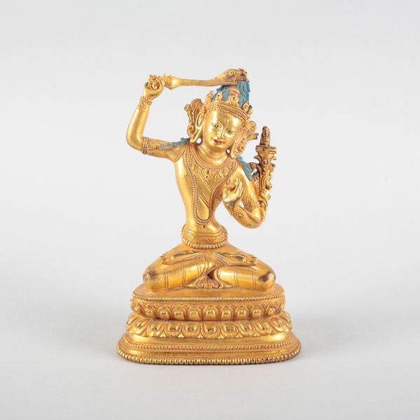 A SINO-TIBETAN GILT BRONZE FIGURE OF MANJUSHRI