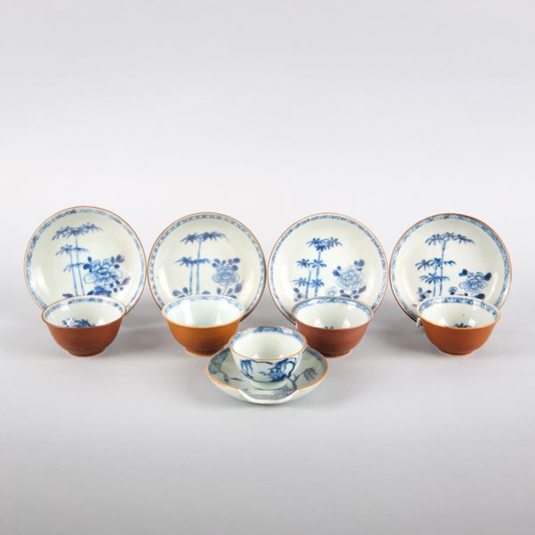 A SET OF FOUR CHINESE PORCELAIN BLUE, WHITE AND CAFE AU LAIT TEA BOWLS AND SAUCERS