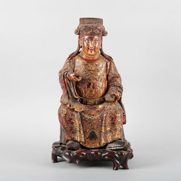 A CHINESE CARVED WOOD AND POLYCHROME PAINTED FIGURE OF A DIGNITARY