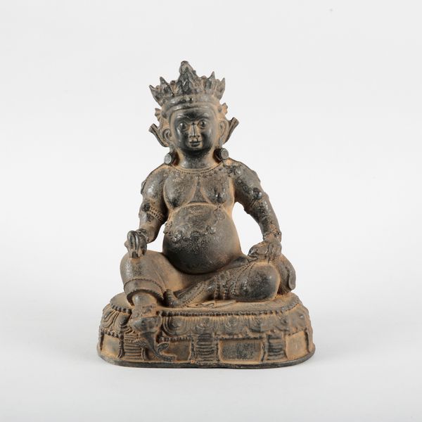 A SINO-TIBETAN BLACK PAINTED METAL FIGURE OF SEATED JAMBHALA