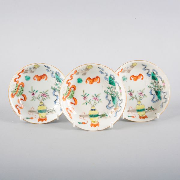 A SET OF THREE CHINESE PORCELAIN FAMILLE ROSE SAUCERS