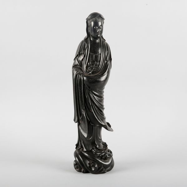 A CHINESE EBONISED WOOD FIGURE OF GUANYIN