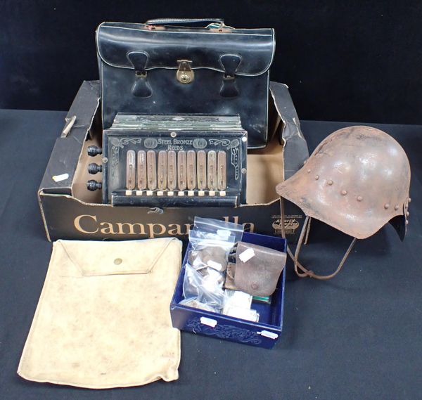 A GERMAN ACCORDION, A TIN HELMET