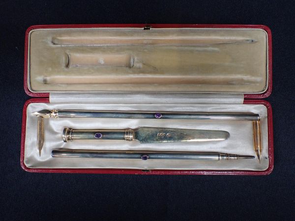 A SILVER GILT BOXED PEN, PENCIL AND LETTER OPENER SET