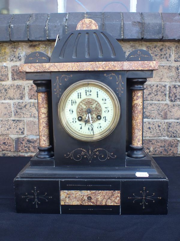 A BLACK SLATE MANTEL CLOCK WITH MARTI & Cie MOVEMENT