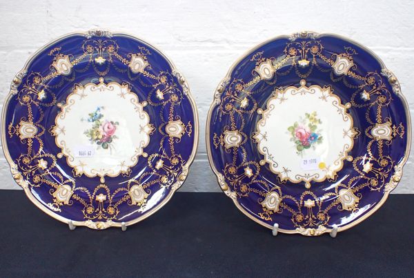 A PAIR OF ROYAL CROWN DERBY PLATES WITH FLORAL CENTRES