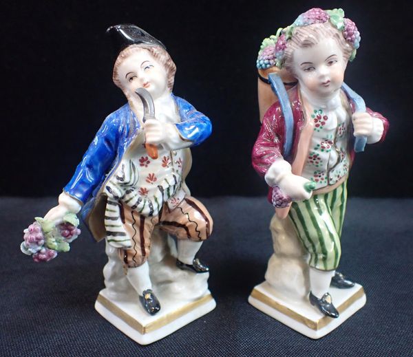 A PAIR OF GDR SITZENDORF PORCELAIN FIGURES OF GRAPE HARVESTERS