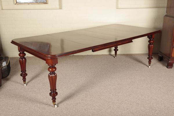 A VICTORIAN MAHOGANY EXTENDING DINING TABLE